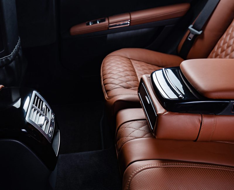 A luxury car interior in brown and black colors