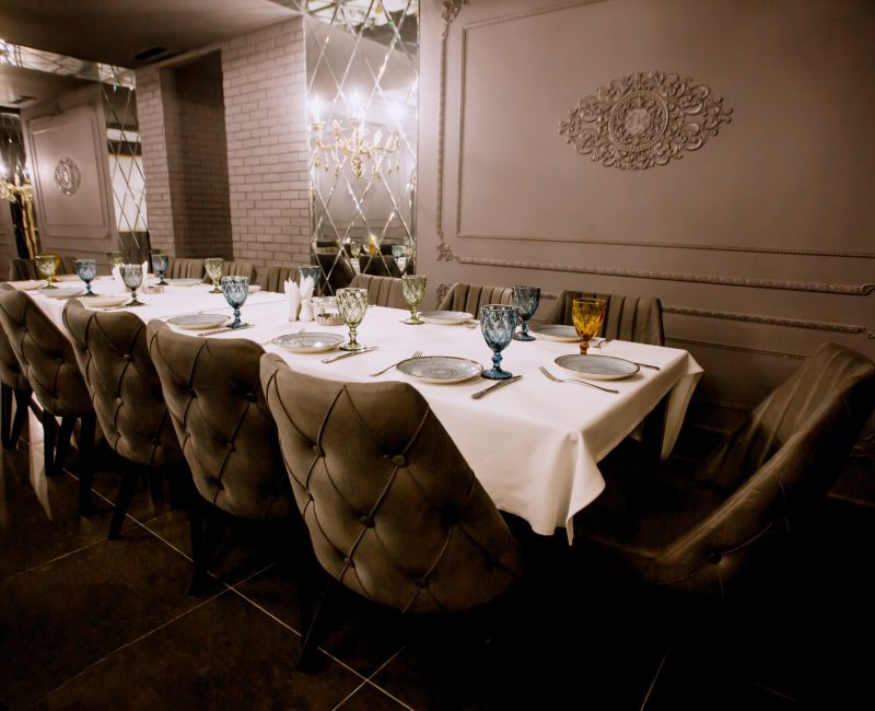 grey painted fancy restaurant with empty dinner table horizontal