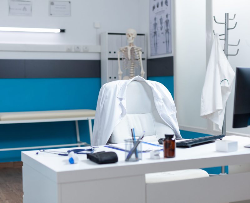 Empty modern medical office having disease documents on table equipped with contemporary furniture. Hospital workplace with nobody in it ready for sickness consultation. Medicine support